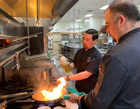 Two people cooking in the kitchen